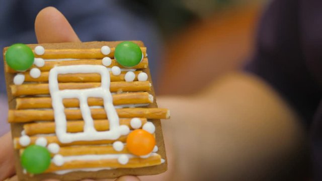 Family traditions. Decoration gingerbread house. Preparing for the holiday of Christmas