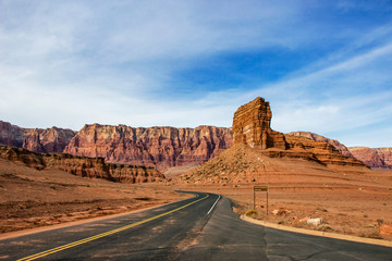 Road leading around stunning red rock butte in the Southwest USA