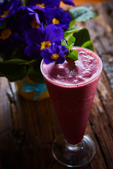 Delicious berry smoothie on table