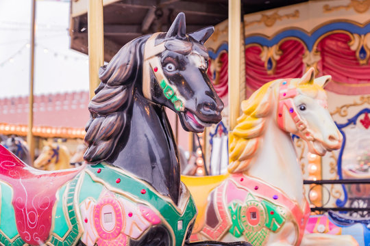 Couple of Vintage carousel horses. Merry-go-round  in a holiday park.