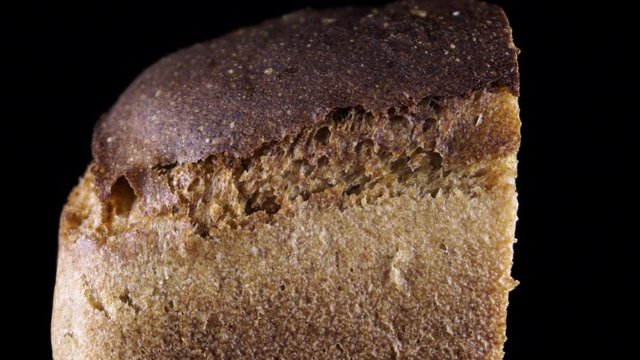 piece of gray bread on a dark background macro slow motion