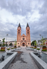 Fototapeta na wymiar The twin-towered Nyiregyháza's Roman Catholic church with the newly built fountain in the foreground