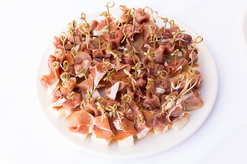 corned beef canapés with melon slices on skewers