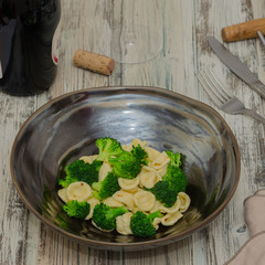 Orecchiette con broccoli. Pasta orecchiette with broccoli on a rustic wooden background