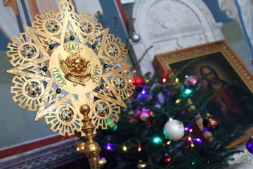 The Orthodox Church. Ripid on the background of the icon and   Christmas trees during the Christmas liturgy