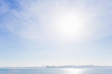 Morning over the river Tagus and mild fog through which barely n