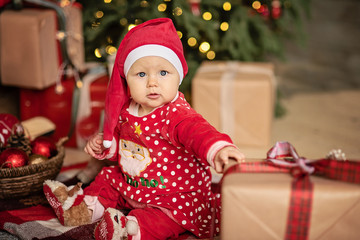 Fototapeta na wymiar The little girl under the Christmas tree