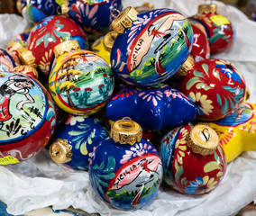Features hand painted ceramic Christmas balls.