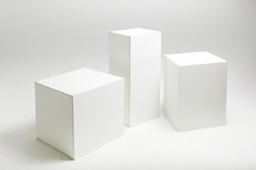 3D illustration of white cubes and parallelepipeds on cyclorama in modern photo studio