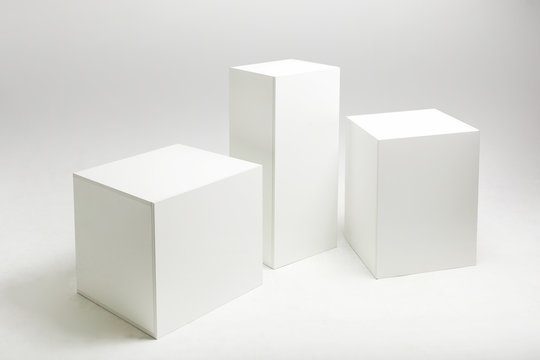 3D Illustration Of White Cubes And Parallelepipeds On Cyclorama In Modern Photo Studio