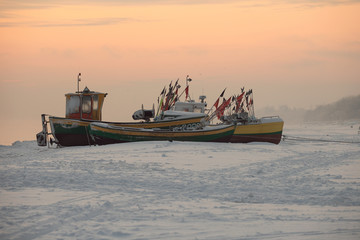 fishing boats on frozen beach, Baltic sea near Sopot town, Poland - obrazy, fototapety, plakaty