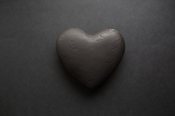 Valentines day background. Black textured heart, isolated on black.