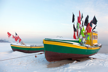 Podmorskie region, Poland - December, 2010: fishing boats on the beach in the winter, Baltic sea near Sopot town