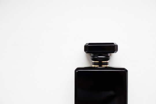 Close-up Of Black Perfume Bottle, Isolated On White.