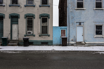 Naklejka premium Two vintage brick buildings on wet street