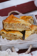 Piece of Meat Pie on winter background. Breakfast on a wooden tray close-up