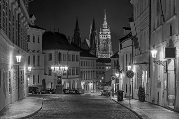 Fototapeta na wymiar Prague - The St. Vitus cathedral and the Loretánská street at night.