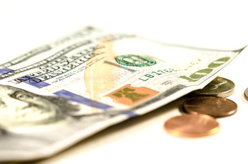 hundread dollars and coin, a group of hundred dollars with few coins over a white background. symbol of wealth