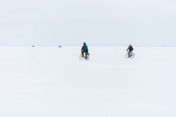 Masuria Region, Poland - January, 2009: cyclists riding on a frozen Sniardwy Lake in winter, Sniardwy is the largest lake in Poland