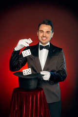 Professional Occupation. Magician in suit and gloves standing isolated on wall showing trick with...