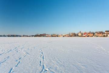 Fototapeta na wymiar Masuria Region, Poland - January, 2009: Mikolajki town and Mikolajskie Lake