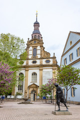 Statue of a pilgrim on his way to santiago de compostela in front of the Holy Trinity Church, Speyer, Germany