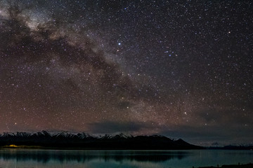 Beautiful milky way, starry night over the snow mountain at Lake Pukaki, New Zealand. High ISO Photography. - obrazy, fototapety, plakaty