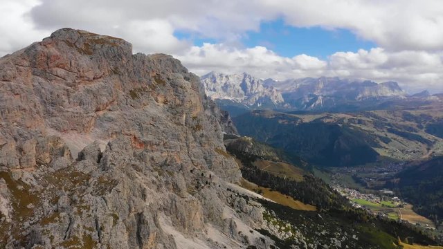 Aerial view of the Paso Gardena Pass in the province of Bolzano. Dolomites. Flying near the Pizes de Cir. In the distant view of a mountain Schelrn. Autumn in Italy