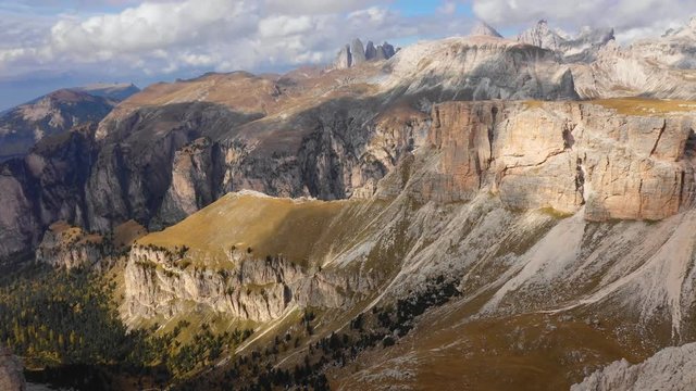 Aerial view of the Paso Gardena Pass in the province of Bolzano. Dolomites. Flying near the Pizes de Cir. In the distant view of a mountain Schelrn. Autumn in Italy