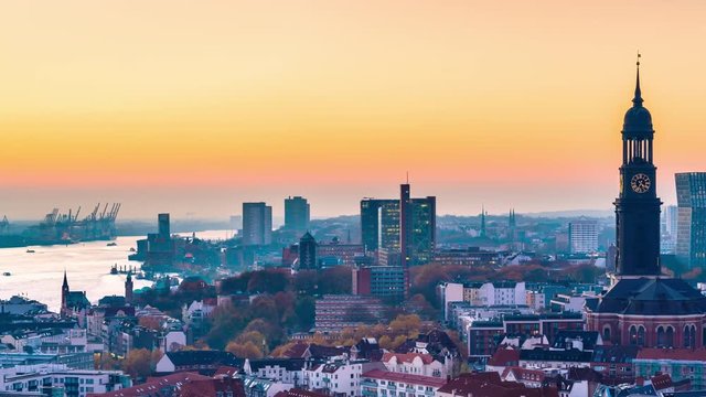 Aerial view of the harbor, St. Michael's Church (German: St. Michaelis) and downtown Hamburg, Germany. 4k UHD time lapse video at dusk with day to night transition.