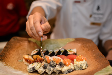Chef arranging sushi plate