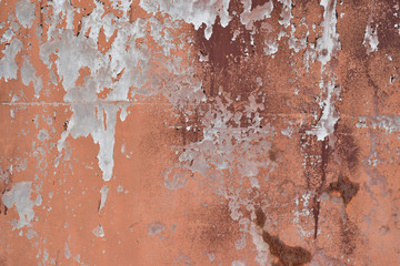 Peeling paint on cement wall texture. Pattern of rustic red grunge.