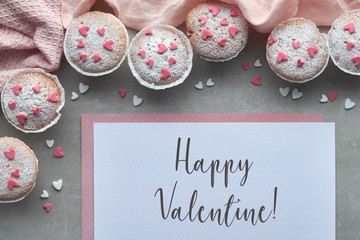 Sugar-sprinkled muffins with pink and white fondant icing hearts, text