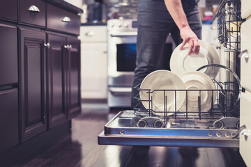Man doing dishes cleaning in the kitchen household chores