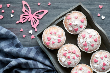 Sugar-sprinkled muffins with pink and white fondant icing hearts