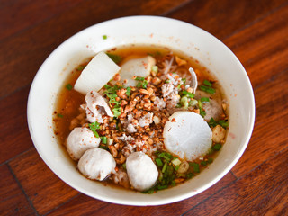 Spicy pork noodle soup with lemongrass chilly pasted and lime juice delicious noodles bowl with meatball pork slice peanut