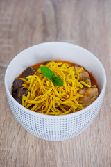 Khao soi - Traditional Thai Food, Khao Soi Thai Noodle Curry Soup with chicken on wood table, Khao soi a famous northern Thai food