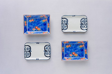 Set of ceramic dishes on table background. Top view