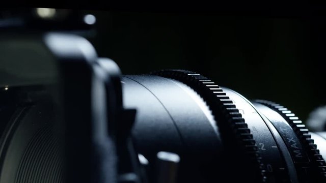 Cinematographer (camera operator) working with a cinema camera at night