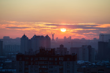 Sunset in Kiev, evening view of the panorama of the city, the church and the statue of the Motherland.  Evening color urban landscape