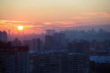 Fototapeta premium Sunset in Kiev, evening view of the panorama of the city, the church and the statue of the Motherland. Evening color urban landscape
