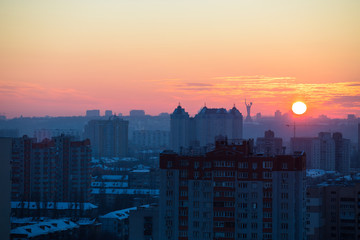 Sunset in Kiev, evening view of the panorama of the city, the church and the statue of the Motherland.  Evening color urban landscape