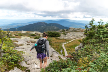female hiker finds her footing hiking along Mount Mansfield in Vermont