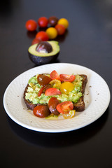 Healthy green veggie avocado toast with tomatoes