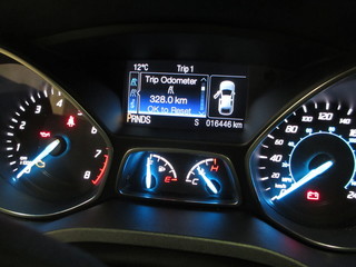 A picture was taken from a modern rental car dashboard to document the mileage for preventive legal...