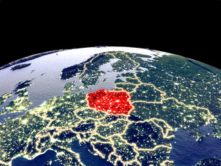 Poland from space on planet Earth at night with bright city lights. Detailed plastic planet surface with real mountains.