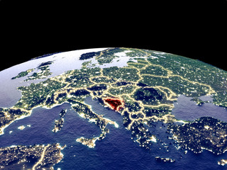 Bosnia and Herzegovina from space on planet Earth at night with bright city lights. Detailed plastic planet surface with real mountains.