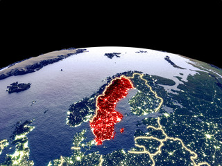 Sweden from space on planet Earth at night with bright city lights. Detailed plastic planet surface with real mountains.