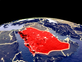 Saudi Arabia from space on planet Earth at night with bright city lights. Detailed plastic planet surface with real mountains.