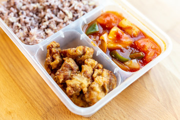 Thai styled organic Sweet and Sour fried with pork and rice berry in food grade box. 